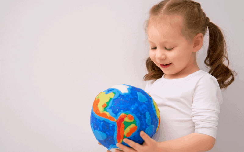 Child holding a globe